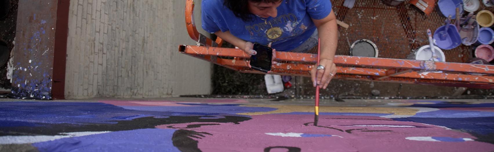 Milkbox The Artist painting a mural at 420 Elizabeth Street in London, Ontario