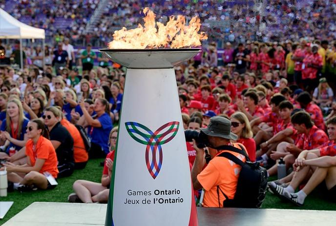 A large crowd gathered at the opening of the London 2024 Ontario Summer Games with a flame lit in the foreground