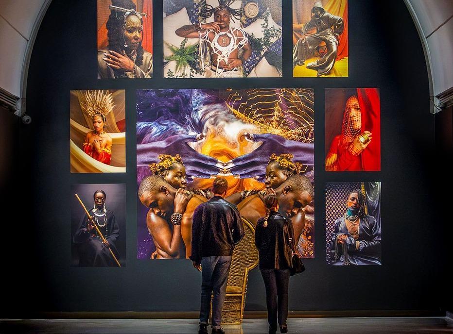 Two people looking at various works of art on display at Museum London, located in London, Ontario