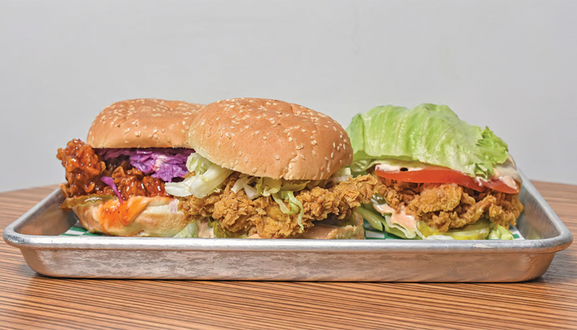 Spread of 3 fried chicken sandwiches on a platter 808 Chicken House