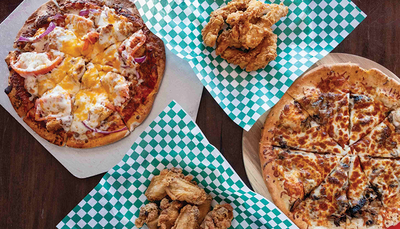 pizza and chicken wings on a table