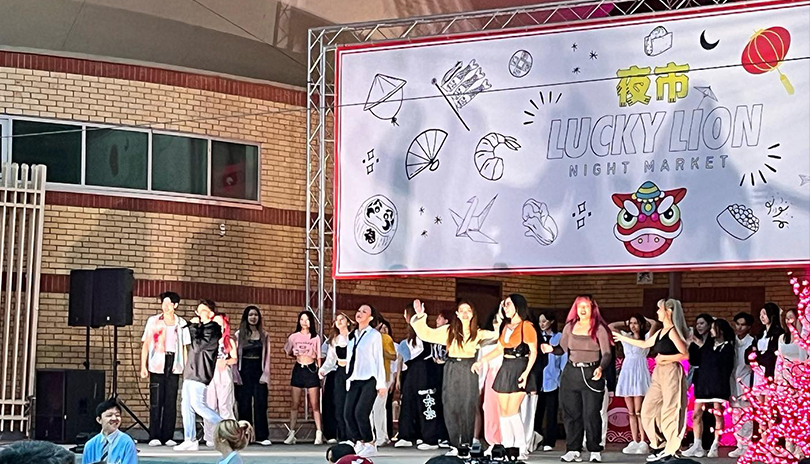 Prerformers gathering on stage to dance at Lucky Lion Night Market