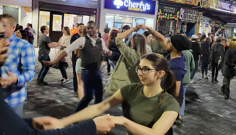 People dancing in the street of Dundas Place in  London, Ontario