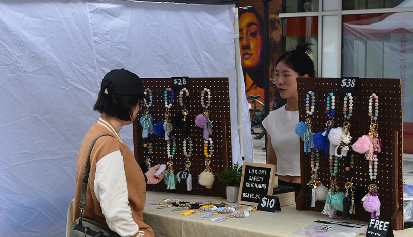 Vendor selling artisan crafts at the Summer Saturday Street Market in Market Lane