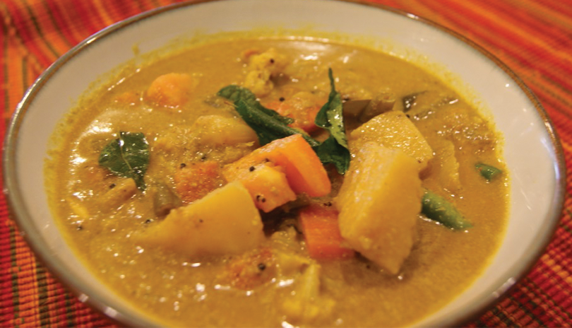 White bowl filled with vegetarian curry at Udupi Krishna