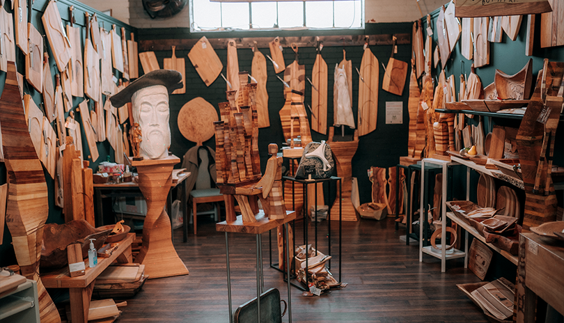 A selection or wooden cheese boards hung up